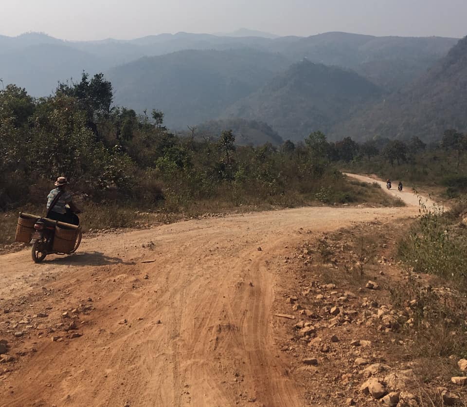 Image shows a winding broken road in Myanmar, highlighting our love of adventure writing, and its ability to captivate readers.